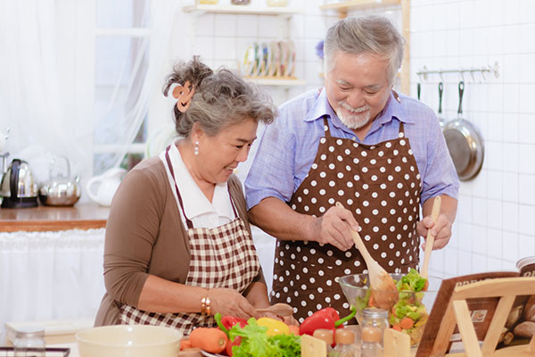 Older couple preparing a salad_healthy aging